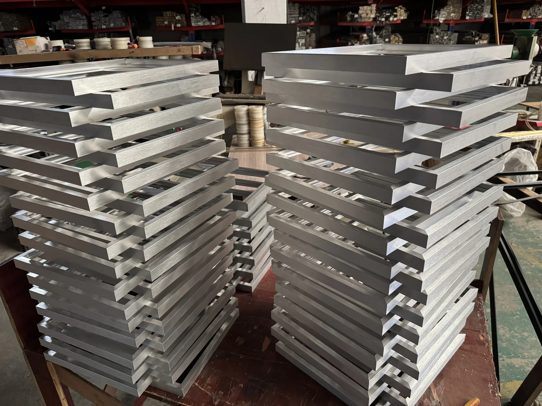 Batch of joined silver aluminium frame rails in DAMAX's workshop